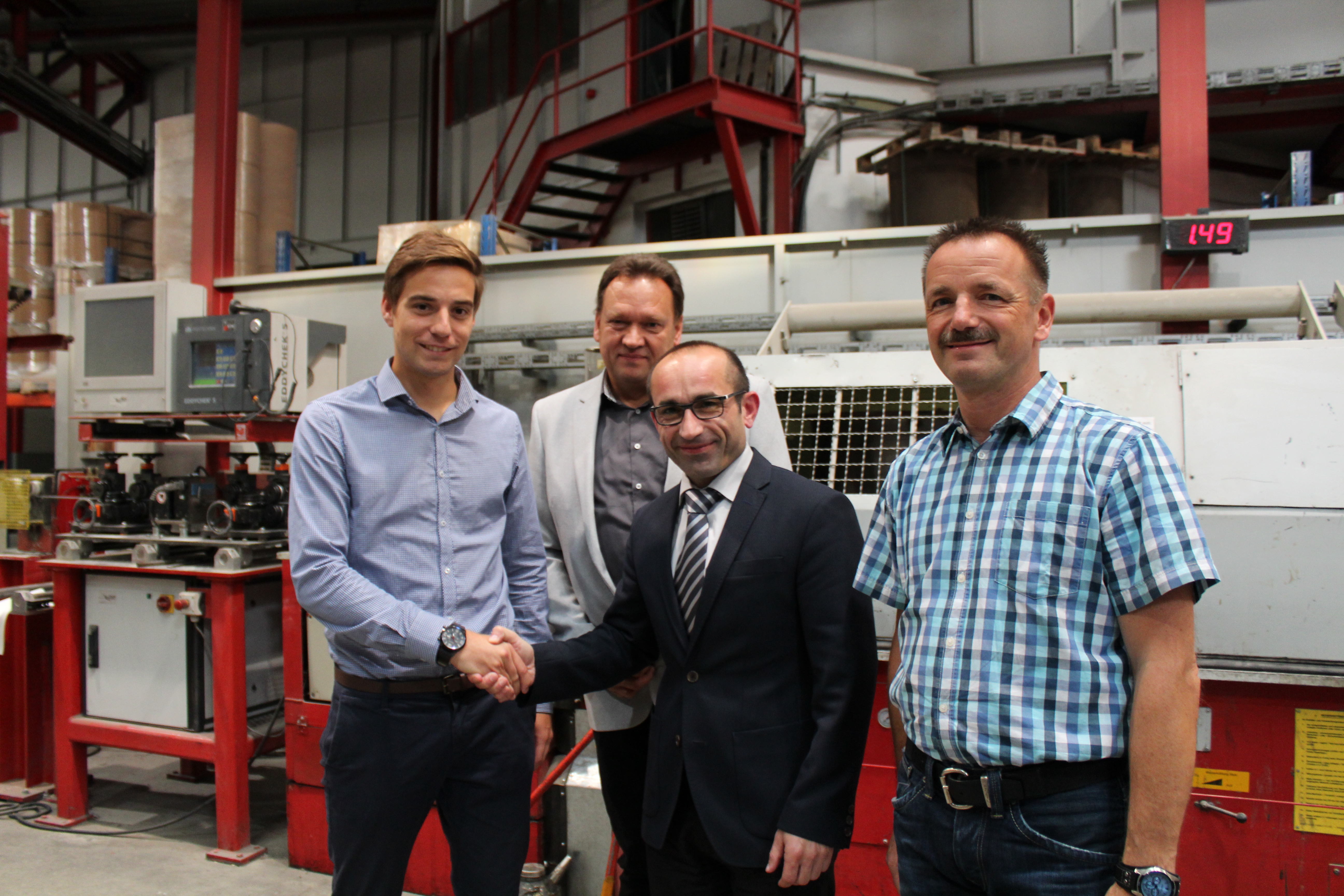 (v.l.n.r.) Matthes Schröder, Jürgen Peter Adolf, Prof. Dr. Klaus-Michael Mende von der Fachhochschule und Uwe Packruhn vor dem Drahtzug